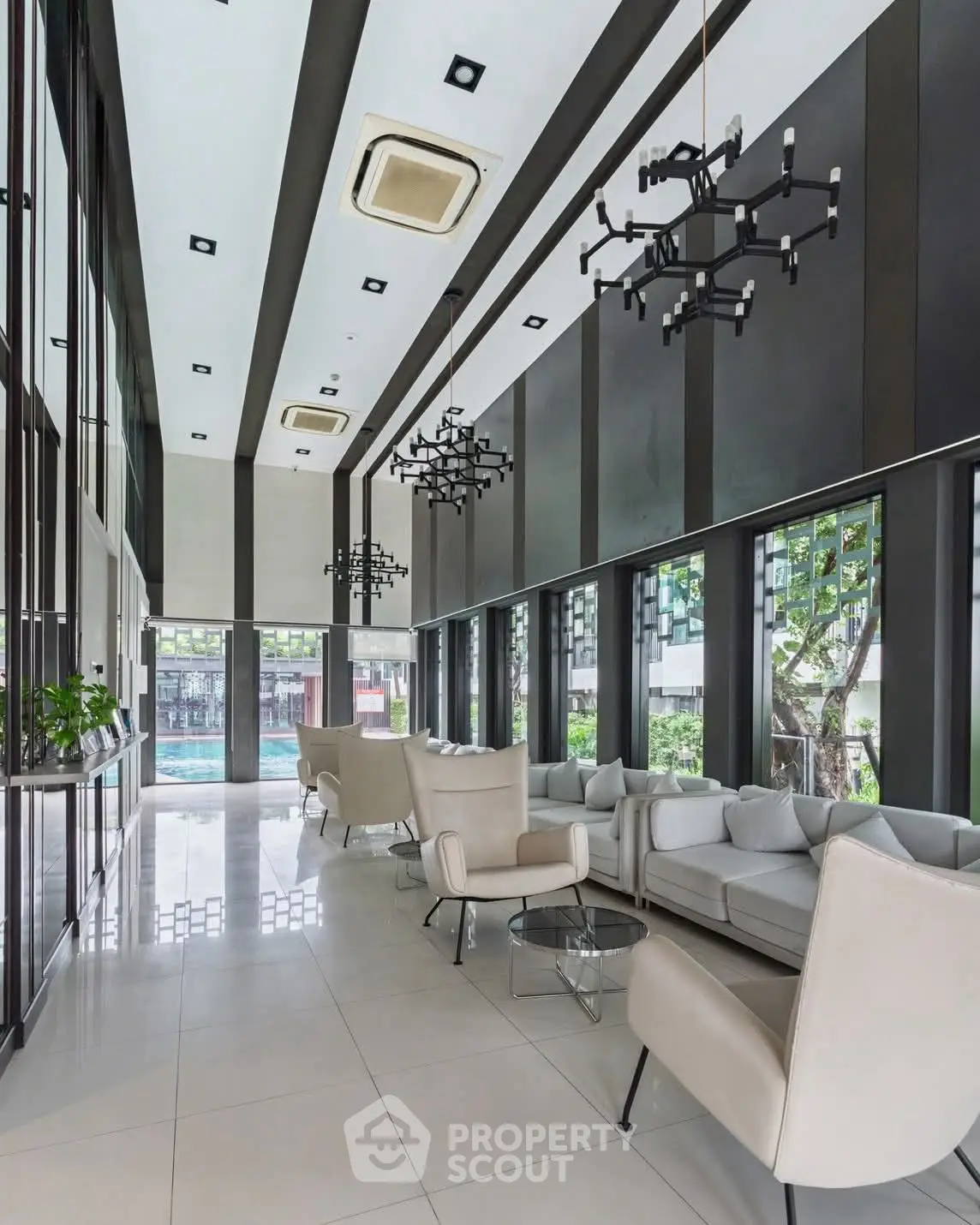 Luxurious modern lobby with high ceilings and elegant seating in a contemporary building.