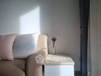 Cozy living room corner with elegant sofa and soft lighting