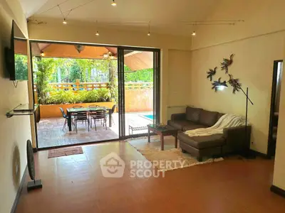 Spacious living room with poolside view and modern decor