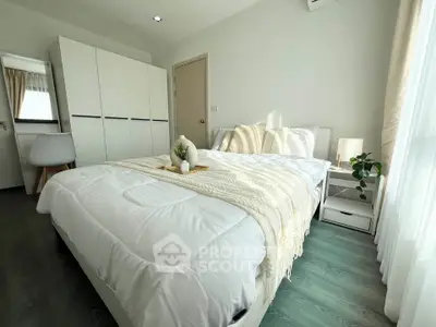 Modern bedroom with cozy decor and ample natural light