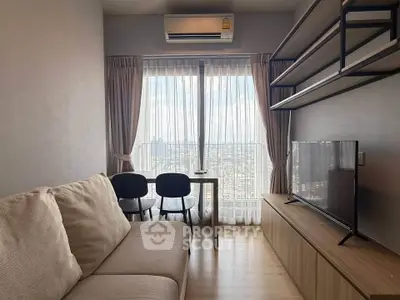 Modern living room with city view, featuring cozy sofa, TV, and dining area by large window.