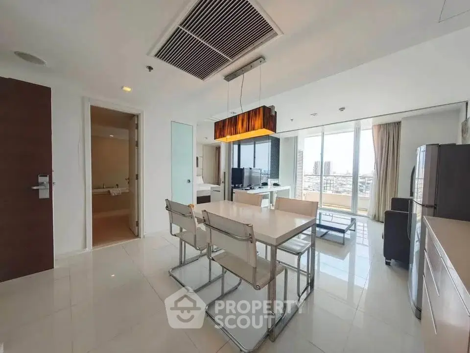 Modern open-layout living room with dining area and city view, featuring sleek furniture and bright natural light.