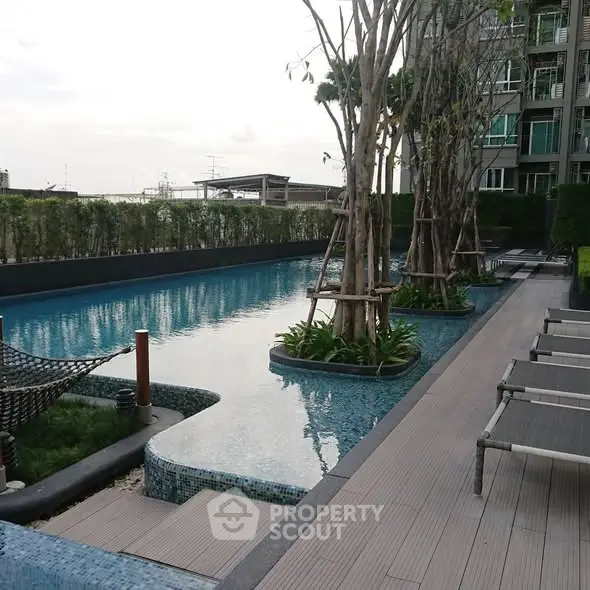 Luxurious apartment complex with serene poolside and modern amenities.