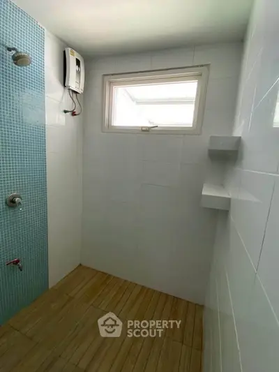 Modern bathroom with tiled shower and natural light window