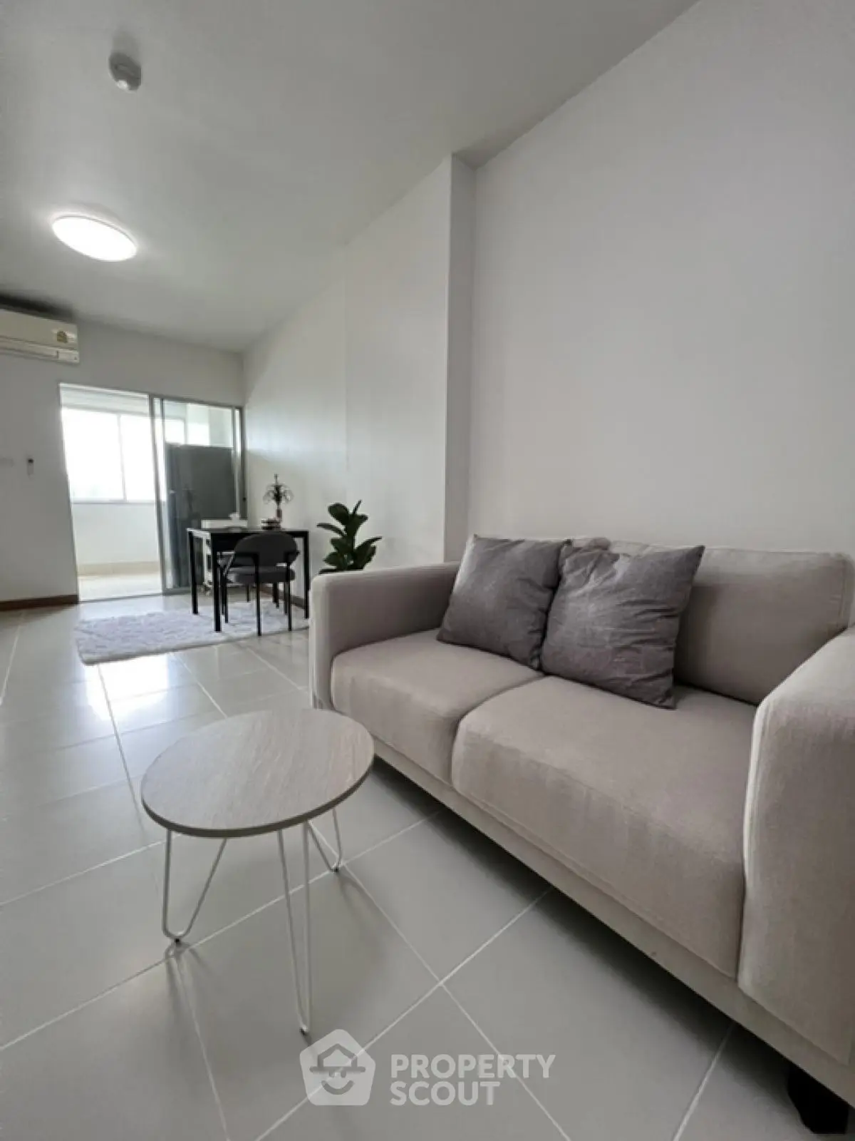 Modern living room with sleek sofa and minimalist decor in bright apartment