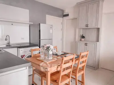 Charming kitchen with wooden dining set and modern appliances in cozy apartment.