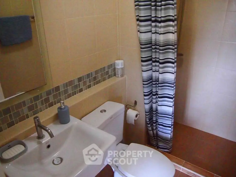 Cozy bathroom with modern fixtures and stylish shower curtain