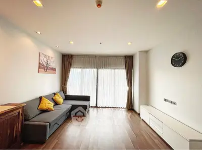 Spacious living room with modern decor and large windows for natural light.