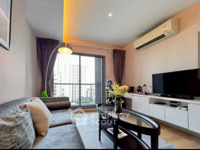 Modern living room with city view, stylish furniture, and air conditioning in a high-rise apartment.