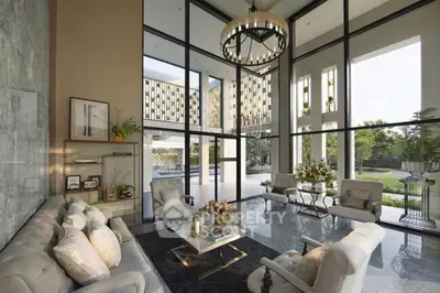 Luxurious living room with high ceilings and large windows offering garden views.