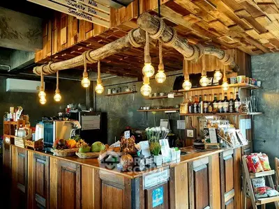 Charming rustic cafe interior with wooden decor and hanging lights, perfect for cozy gatherings.