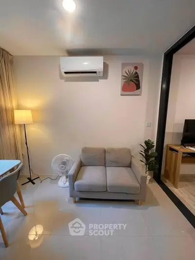 Modern living room with air conditioning, cozy sofa, and stylish decor in a contemporary apartment.