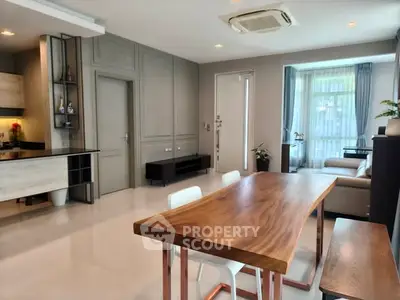 Spacious modern living room with elegant dining area and natural light