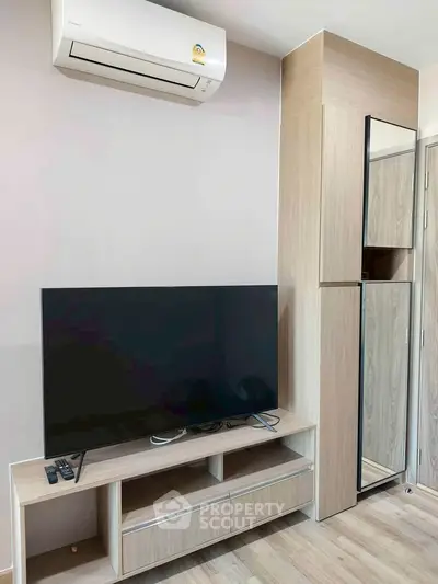 Modern living room with sleek TV setup and air conditioning