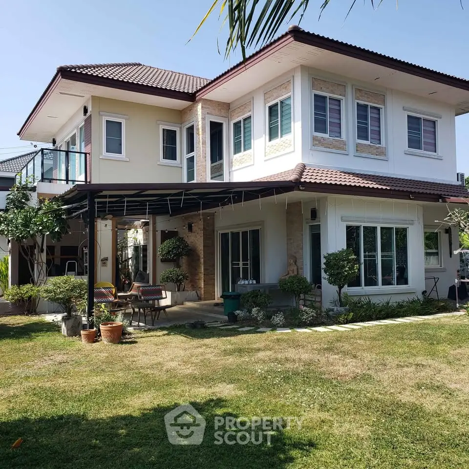 Charming two-story house with lush garden and spacious lawn in a serene neighborhood.