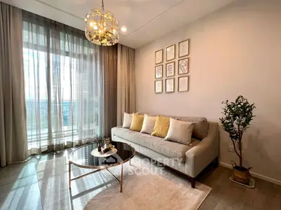Stylish living room with elegant decor and large window offering natural light.