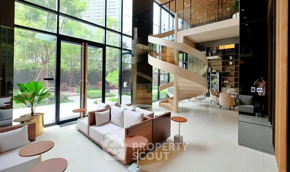 Luxurious modern living room with spiral staircase and garden view