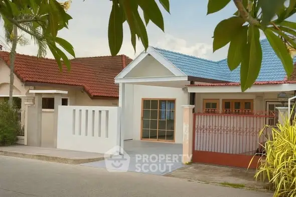 Charming suburban house with colorful roof and gated entrance