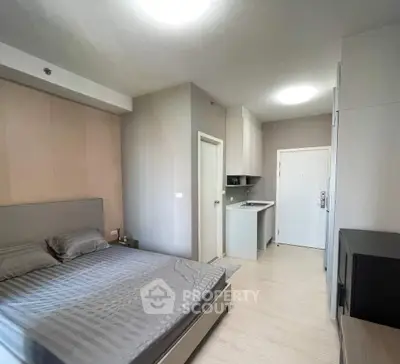 Modern studio apartment with sleek design and compact kitchen area