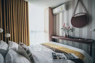 Chic bedroom with modern decor, featuring a cozy bed, stylish mirror, and elegant lighting.