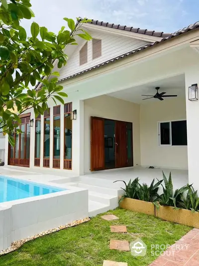 Modern house with pool and lush garden, featuring spacious patio and elegant wooden accents.