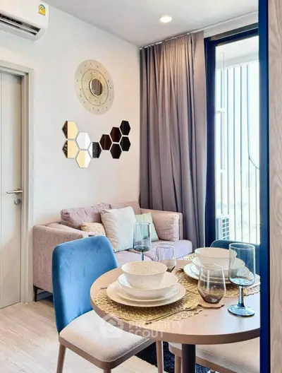 Chic modern living room with stylish decor and dining area in a cozy apartment.
