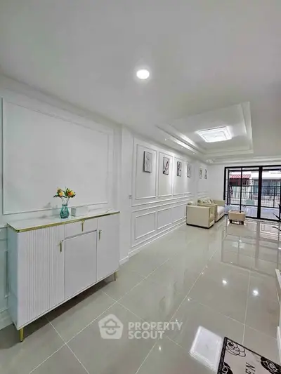 Elegant living room with modern decor and spacious layout, featuring stylish furniture and bright natural lighting.