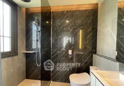 Luxurious modern bathroom with sleek black marble walls and elegant fixtures