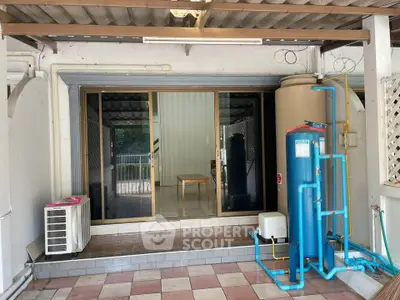 Spacious patio with water filtration system and sliding glass doors leading to interior.
