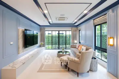 Luxurious living room with elegant decor and large windows overlooking a lush garden.