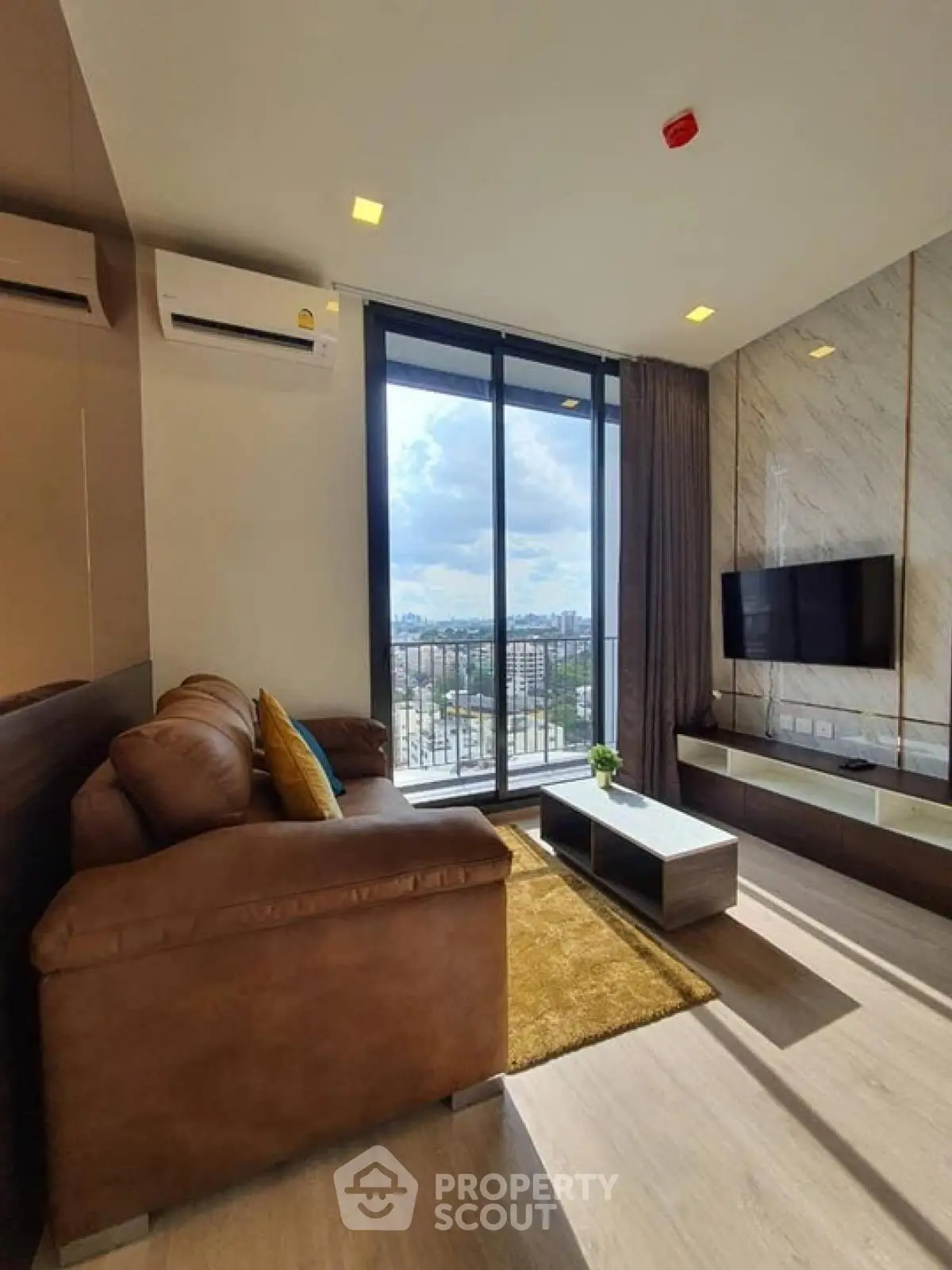 Modern living room with leather sofa and city view balcony in luxury apartment