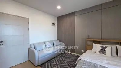 Modern bedroom with stylish decor and cozy seating area