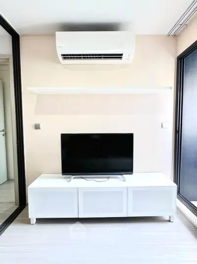 Modern living room with sleek TV stand and air conditioning unit, perfect for comfortable urban living.