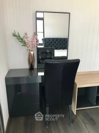 Modern bedroom with stylish black leather chair and sleek vanity desk