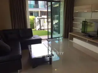 Spacious living room with modern furniture and garden view, ideal for relaxation and entertainment.