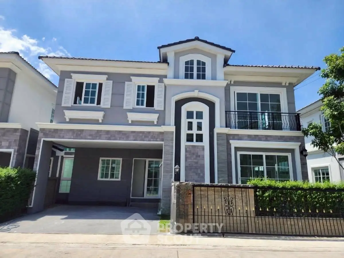 Elegant two-story house with modern facade and spacious driveway in a serene neighborhood.