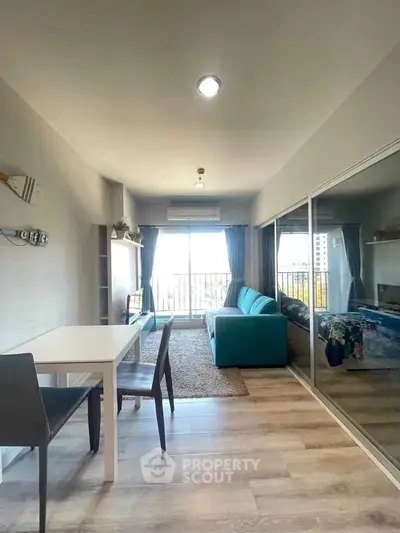 Modern living room with large windows and stylish furniture in a bright apartment.