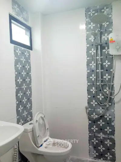 Modern bathroom with stylish tile design and shower in a contemporary home.