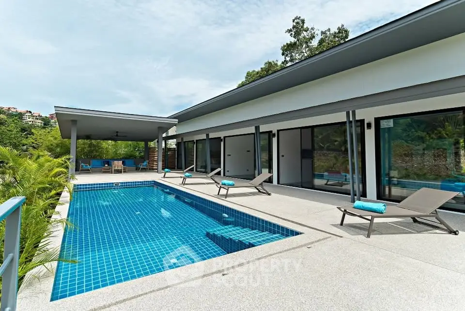 Luxurious modern villa with private pool and spacious terrace in tropical setting.