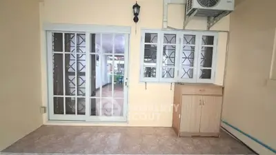 Cozy interior space with sliding glass doors and air conditioning, perfect for relaxation or storage.