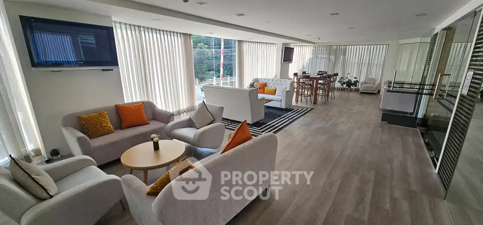 Spacious modern living room with elegant furniture and large windows