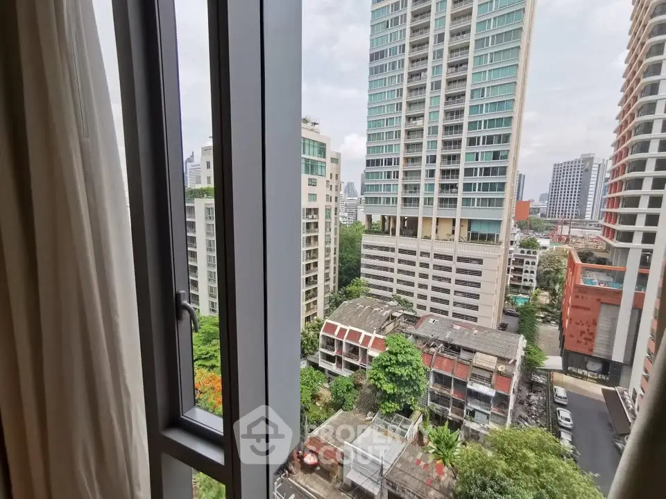 Stunning cityscape view from a high-rise apartment window, showcasing modern urban living.