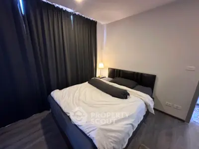 Cozy bedroom with modern decor and soft lighting, featuring a comfortable bed and elegant curtains.