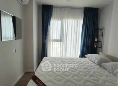Modern bedroom with large window and stylish curtains, featuring a comfortable bed and wall-mounted TV.