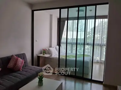 Modern studio apartment with glass partition and cozy decor