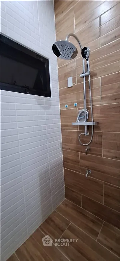 Modern bathroom with stylish shower and wood-like tiles