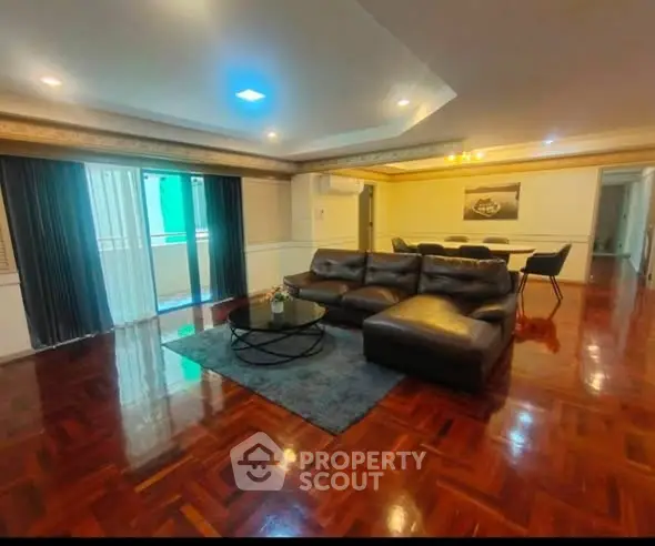 Spacious living room with elegant wooden flooring and modern furniture