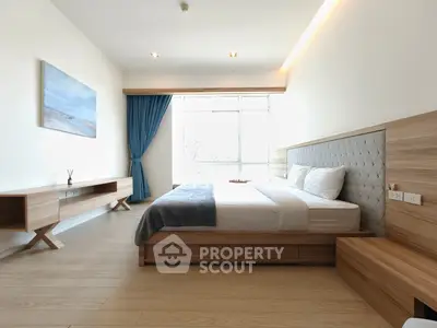 Modern bedroom with elegant wooden furniture and large window for natural light