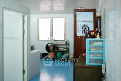 Spacious bathroom with blue tiles and storage solutions