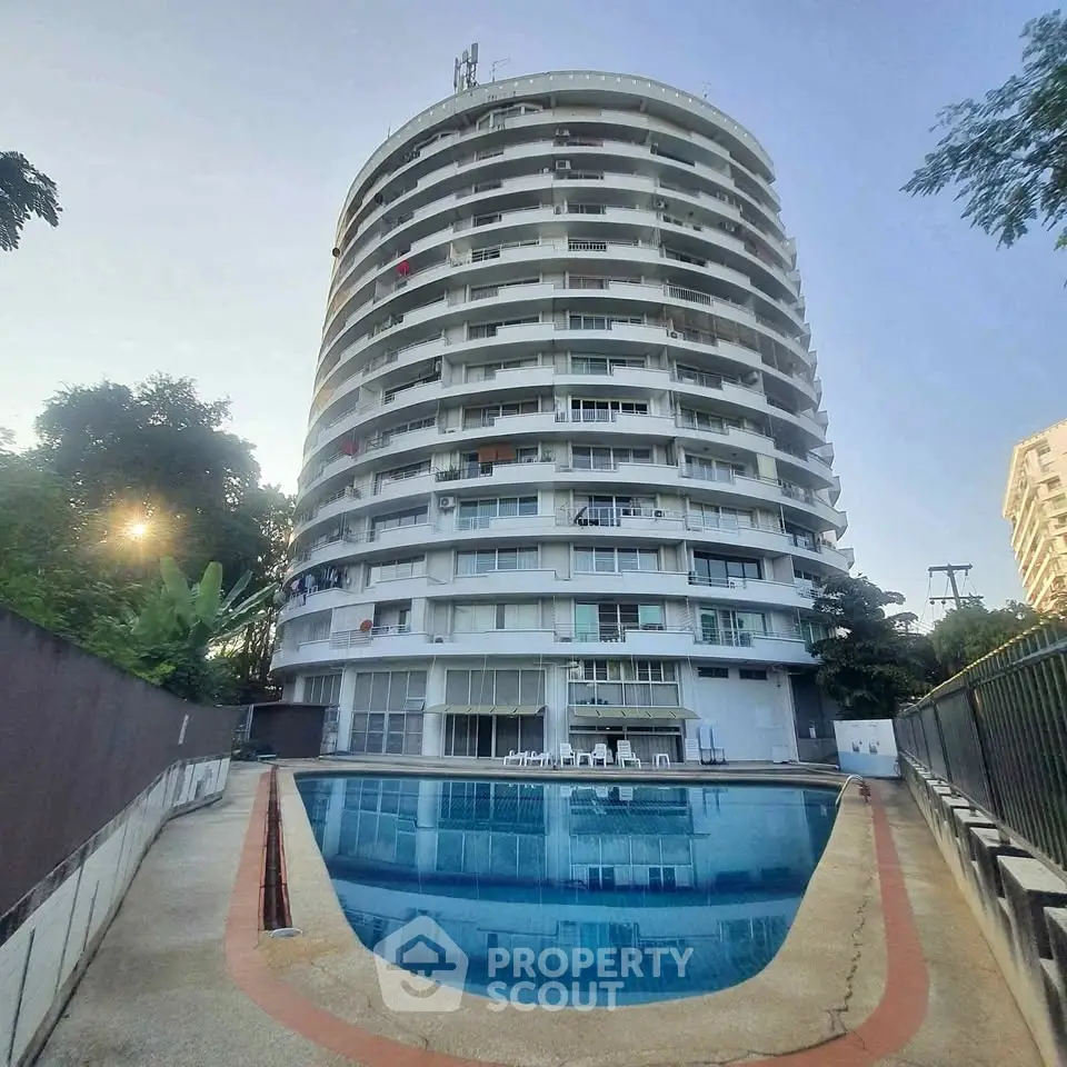 Stunning high-rise building with a refreshing pool, perfect for modern urban living.